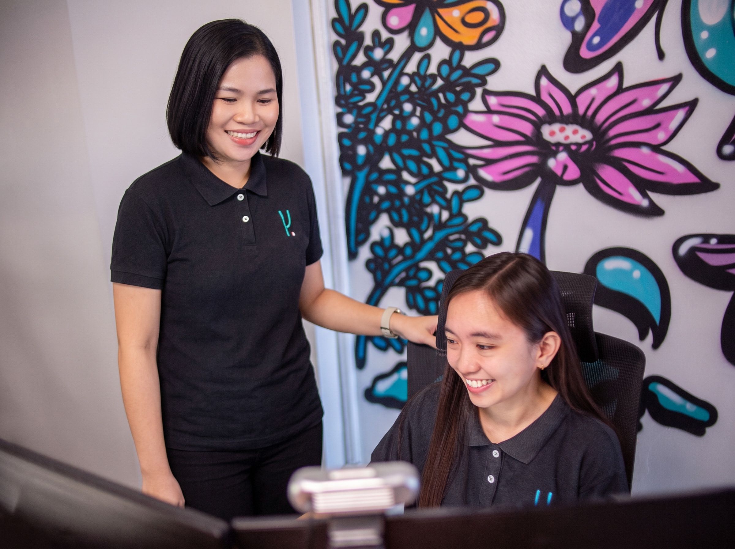 Yoonet teammates supporting each other at their workstation