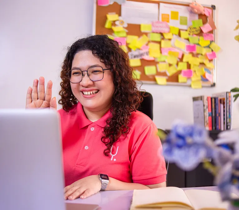 Yoonet team member smiling during a video call with a client